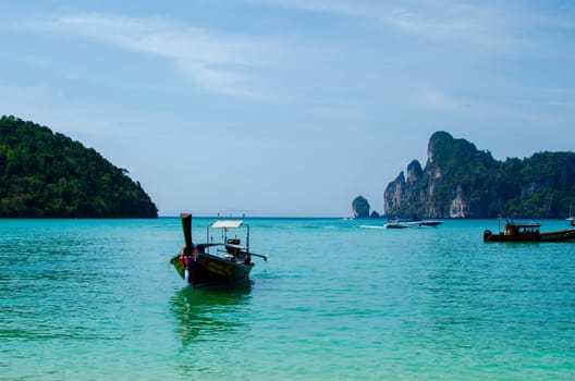 Views of the Islands of Thailand and turquoise water, rocks, yachts or boats.