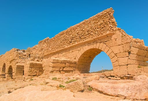 Ancient Roman aqueduct in Caesarea National Park, Israel.