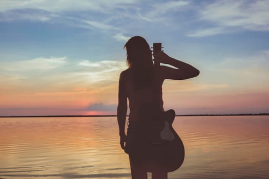 Joyful feeling satisfaction traveller, woman alone with acoustic guitar in summer time vacation leisure. pretty lady lifestyle. download