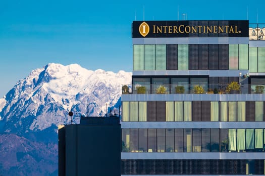 Ljubljana, Slovenia - December 23, 2023: The facade of the InterContinental hotel building close up and the snowy Alps in the background