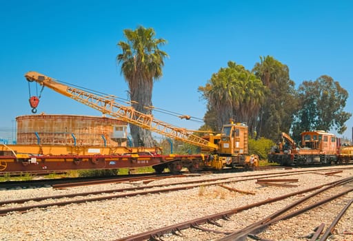 Haifa, Israel - 10 May, 2023: View of a railway crane and oil storage tank in the open area of ​​the Israel Railway Museum.