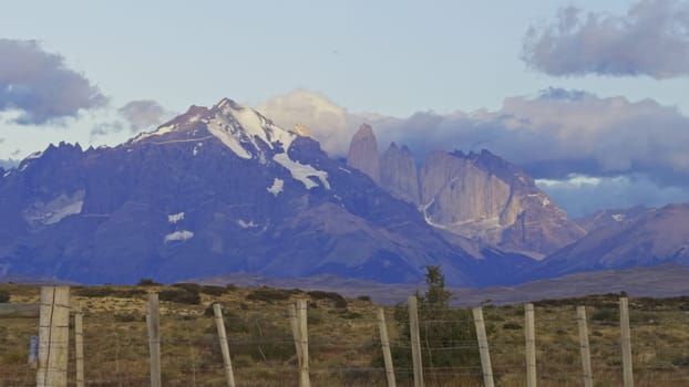 Sunrise illuminates Torres del Paine, highlighting the iconic peaks and mountains.
