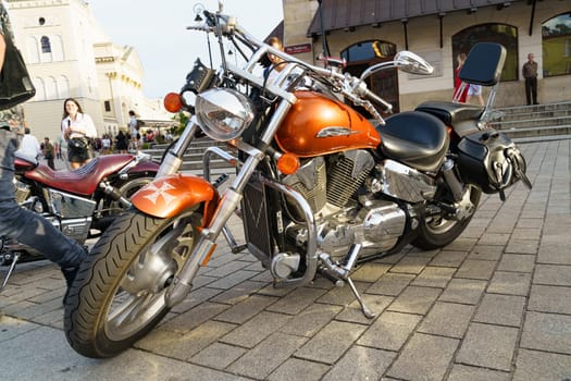 Warsaw, Poland - August 6, 2023: Classic motorcycle Honda VTX 1300. Beautiful chrome-plated orange motorcycle.