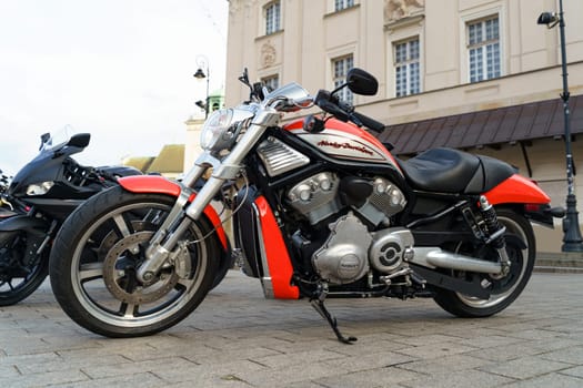 Warsaw, Poland - August 6, 2023: A Harley Davidson motorcycle is parked in a parking lot, side view.