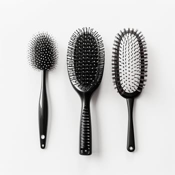 Three different hairbrushes against a white background