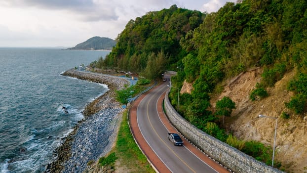 car driving on the curved road of Thailand. road landscape in summer. it's nice to drive on the beachside highway. Chantaburi Province Thailand, beautiful coastal ride