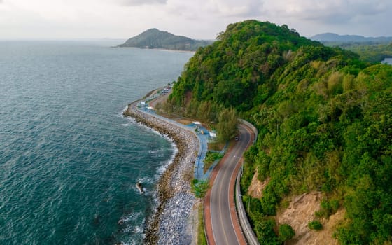 car driving on the curved road of Thailand. road landscape in summer. it's nice to drive on the beachside highway. Chantaburi Province Thailand, beautiful ocean road at sunset
