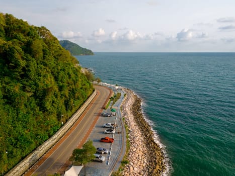 car driving on the curved road alongside the ocean beach road of Thailand. road landscape in summer. it's nice to drive on the beachside highway. Chantaburi Province Thailand,