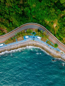 car driving on the curved road alongside the ocean beach road of Thailand. road landscape in summer. it's nice to drive on the beachside highway. Chantaburi Province Thailand,