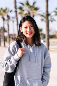 portrait of young asian college girl dressed in casual clothes smiling looking at camera, student lifestyle concept, copy space for text