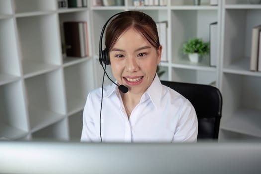 Call center agents wear headphones to talk to customers. Provide consultation via online channels on laptops.