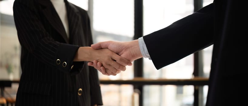Businessmen shake hands after a meeting, congratulating colleagues and reaching a business agreement..