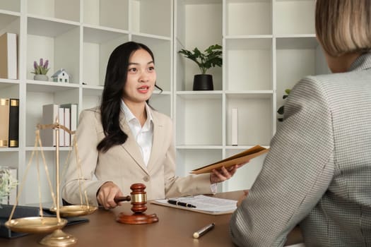 A young lawyer and businesswoman are discussing legal advice on signing a business contract. Insurance or financial contract signing.