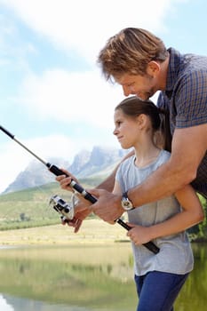 Father, kid and fishing in nature for learning, teaching and outdoor with holiday, travel or sustainable living. Happy family, dad or fisherman with girl or child by river, water or lake for camping.