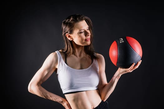 Strong woman does exercise with a med ball slams. Strength and motivation.
