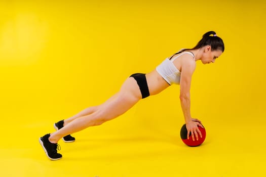 Strong woman does exercise with a med ball slams. Strength and motivation.