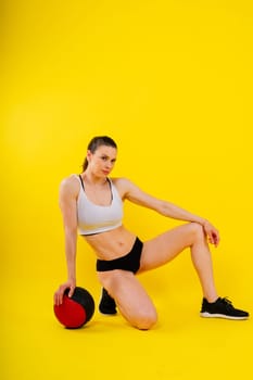 Strong woman does exercise with a med ball slams. Strength and motivation.