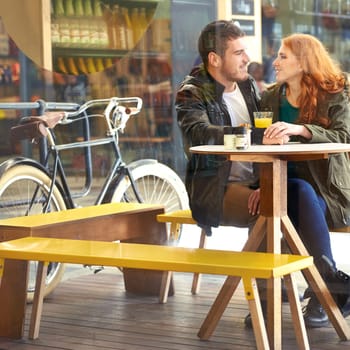 Look, happy and couple in cafe for care on date for relationship anniversary with commitment, support and trust. Man, woman and in love together, hand holding and affection in restaurant for bonding