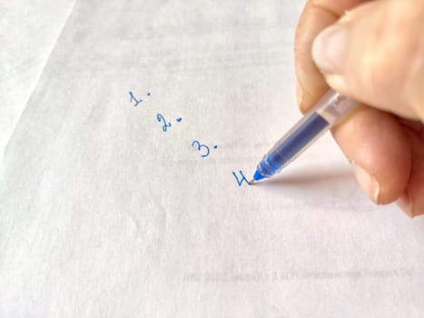 Handwriting Personal To-Do List on Paper. Close-up of a handwriting a to-do list