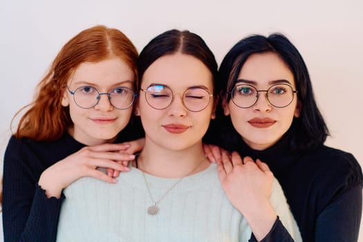 Familial love and unity as three sisters embrace each other against a pure white backdrop, symbolizing the enduring bond of sisterhood.