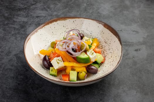 Greek salad in a clay bowl isolated on gray. Side view. Restaurant menu