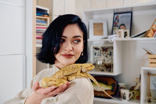 A beautiful woman in a joyful moment, posing with her two adorable bearded dragon pets, radiating love and companionship.