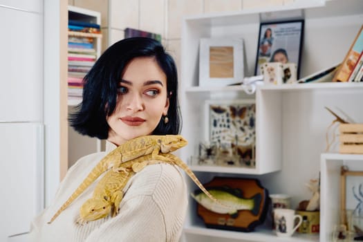 A beautiful woman in a joyful moment, posing with her two adorable bearded dragon pets, radiating love and companionship.