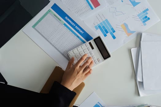 Business finance concept, Business woman using calculator to calculate business data at office.