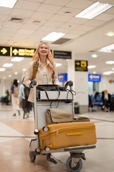 Happy asian tourist woman with backpack and luggage traveling between waits for flight in airport terminal, Tourist journey trip concept.