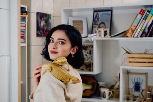 A beautiful woman in a joyful moment, posing with her two adorable bearded dragon pets, radiating love and companionship.