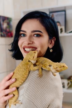 A beautiful woman in a joyful moment, posing with her two adorable bearded dragon pets, radiating love and companionship.