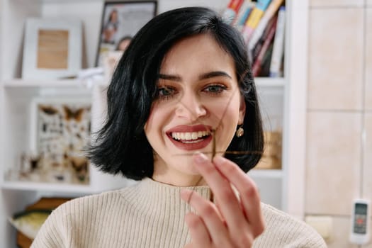 A serene moment as a young woman poses with her beloved stick insect, showcasing the unique bond between human and arachnid.