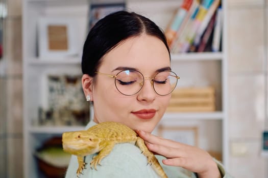 A beautiful woman in a joyful moment, posing with her adorable bearded dragon pets, radiating love and companionship.