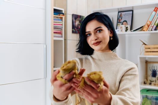 A beautiful woman in a joyful moment, posing with her two adorable bearded dragon pets, radiating love and companionship.