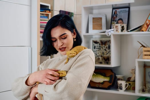 A beautiful woman in a joyful moment, posing with her two adorable bearded dragon pets, radiating love and companionship.