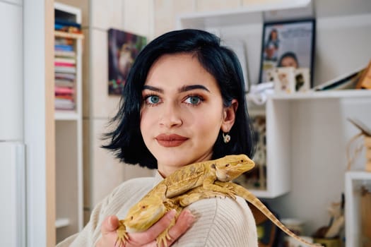 A beautiful woman in a joyful moment, posing with her two adorable bearded dragon pets, radiating love and companionship.