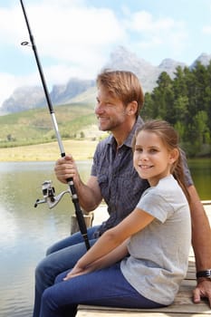 Father, child and fishing in nature for teaching, learning and outdoor with holiday, travel or sustainable living in portrait. Happy family, dad or fisherman with girl by water or lake for adventure.