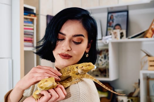 A beautiful woman in a joyful moment, posing with her two adorable bearded dragon pets, radiating love and companionship.