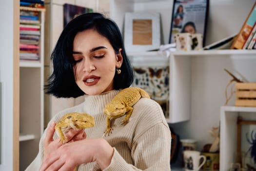 A beautiful woman in a joyful moment, posing with her two adorable bearded dragon pets, radiating love and companionship.