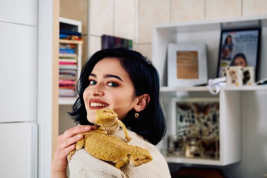 A beautiful woman in a joyful moment, posing with her two adorable bearded dragon pets, radiating love and companionship.