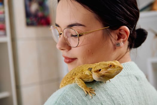 A beautiful woman in a joyful moment, posing with her adorable bearded dragon pets, radiating love and companionship.