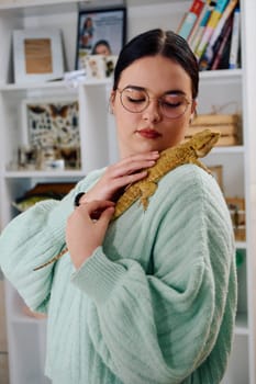 A beautiful woman in a joyful moment, posing with her adorable bearded dragon pets, radiating love and companionship.