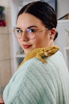 A beautiful woman in a joyful moment, posing with her adorable bearded dragon pets, radiating love and companionship.