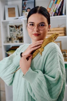 A beautiful woman in a joyful moment, posing with her adorable bearded dragon pets, radiating love and companionship.