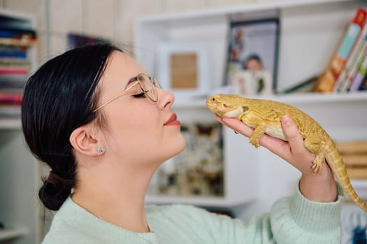 A beautiful woman in a joyful moment, posing with her adorable bearded dragon pets, radiating love and companionship.