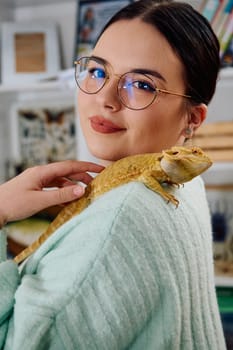 A beautiful woman in a joyful moment, posing with her adorable bearded dragon pets, radiating love and companionship.