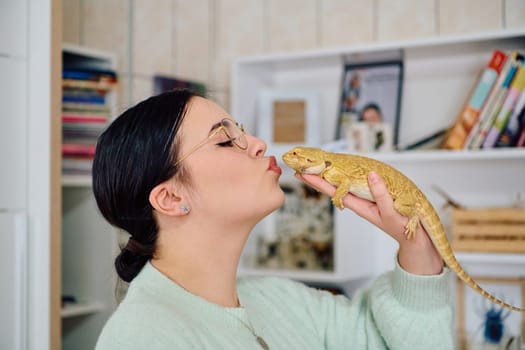 A beautiful woman in a joyful moment, posing with her adorable bearded dragon pets, radiating love and companionship.