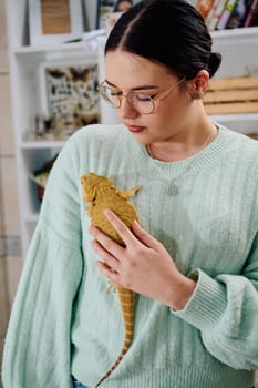 A beautiful woman in a joyful moment, posing with her adorable bearded dragon pets, radiating love and companionship.