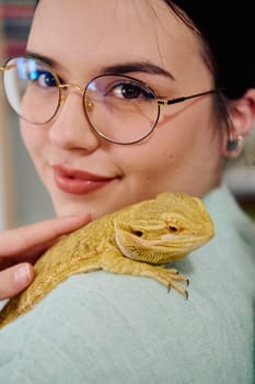 A beautiful woman in a joyful moment, posing with her adorable bearded dragon pets, radiating love and companionship.