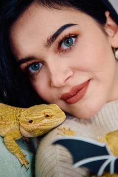 A beautiful woman in a joyful moment, posing with her adorable bearded dragon pets, radiating love and companionship.